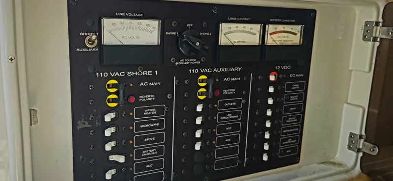 Slide: The Image of Electrical control panel on a 1999 Cobalt 293 boat, featuring voltage and load gauges. - 15
