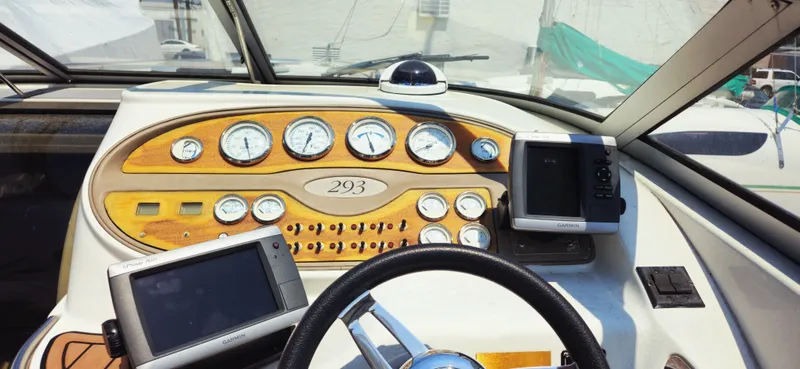 Slide: The Image of Dashboard of a 1999 Cobalt 293 boat with gauges and Garmin navigation devices. - 3