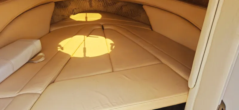 Slide: The Image of Interior cabin of a 1999 Cobalt 293 boat with beige upholstery. - 14