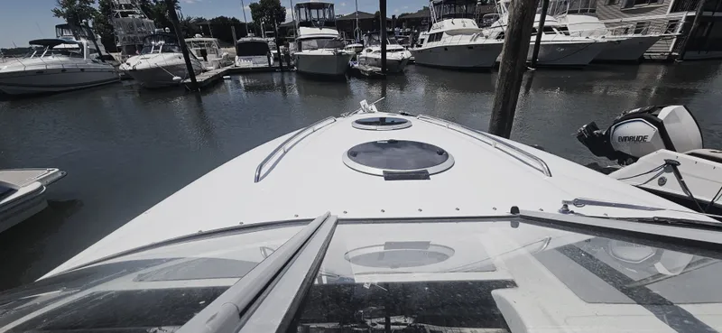Slide: The Image of 1999 Cobalt 293 boat docked in a marina with other vessels. - 18