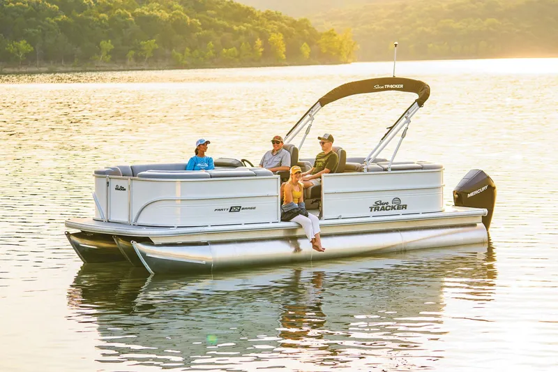 Slide: The Image of 2026 Sun Tracker Party Barge 22 XP3 pontoon boat on trailer, parked outdoors. - 5
