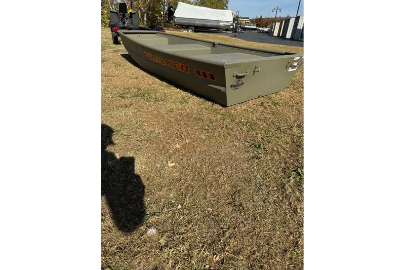Slide: The Image of 2026 Tracker Grizzly 10 Jon boat on grass, showcasing its sturdy design. - 2