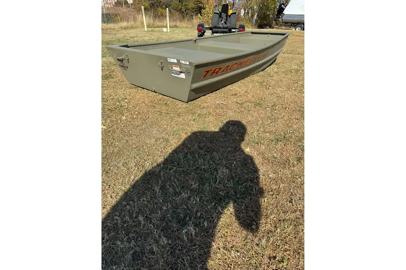 Slide: The Image of 2026 Tracker Grizzly 10 Jon boat on grass, shadow in foreground. - 3
