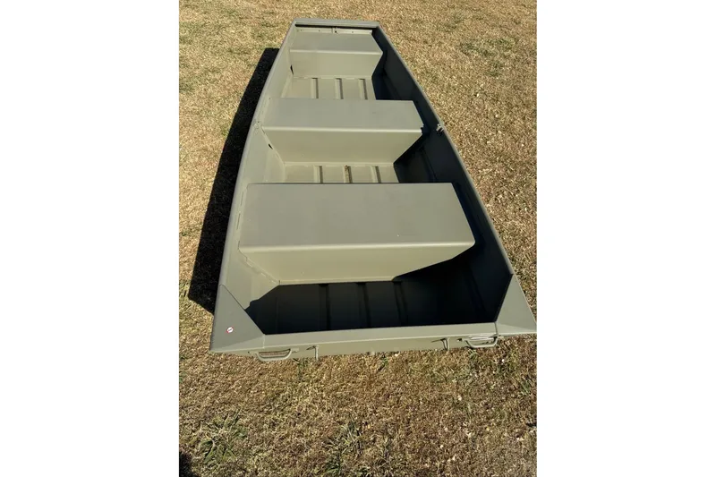Slide: The Image of 2026 Tracker Grizzly 10 Jon boat on grass, showcasing its sturdy design. - 4