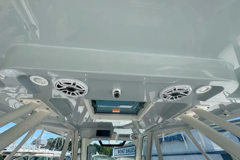 Slide: The Image of 2024 Pursuit S 328 Sport boat interior with speakers and lighting fixtures. - 10