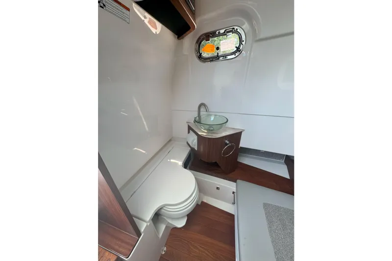 Slide: The Image of 2024 Pursuit S 328 Sport boat interior with modern bathroom amenities. - 12