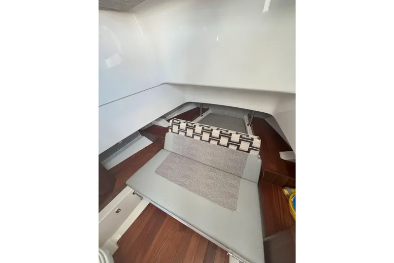 Slide: The Image of 2024 Pursuit S 328 Sport cabin interior with modern seating and wooden flooring. - 14