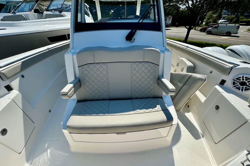 Slide: The Image of 2024 Pursuit S 328 Sport boat interior with cushioned seating and modern design. - 19