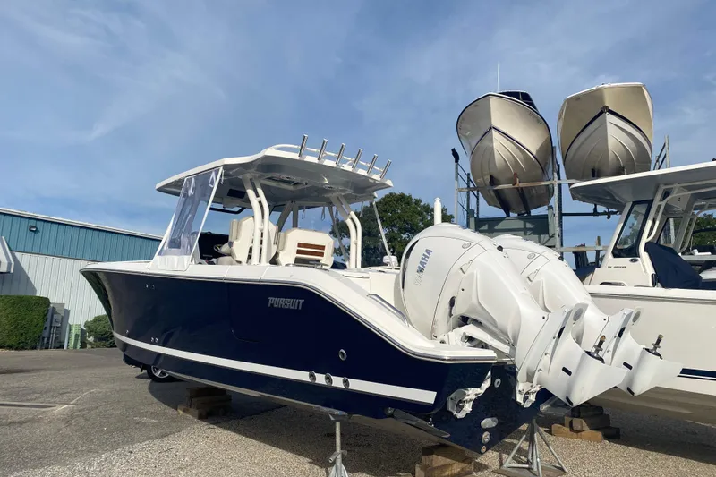 Slide: The Image of 2024 Pursuit S 328 Sport boat with dual Yamaha engines, displayed outdoors. - 2