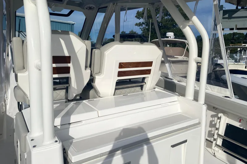 Slide: The Image of 2024 Pursuit S 328 Sport boat interior with white seating and sleek design. - 6