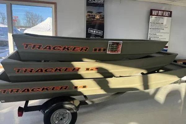 The Image of 2026 Tracker Grizzly 14 Jon boats stacked in showroom on trailer. - 0