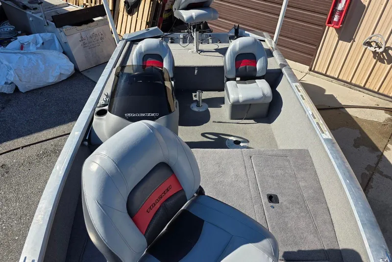 Slide: The Image of 2010 Bass Tracker Pro Crappie 175 boat interior with gray seating and steering console. - 10