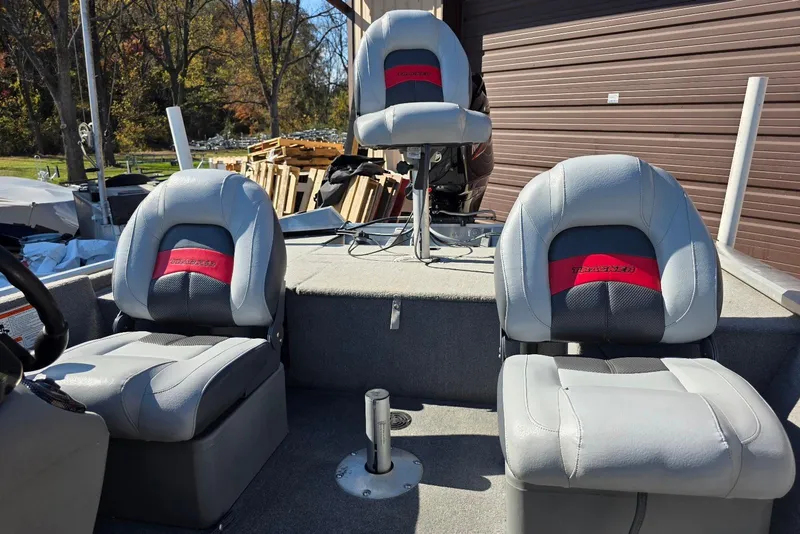 Slide: The Image of 2010 Bass Tracker Pro Crappie 175 boat with three gray and red seats. - 11