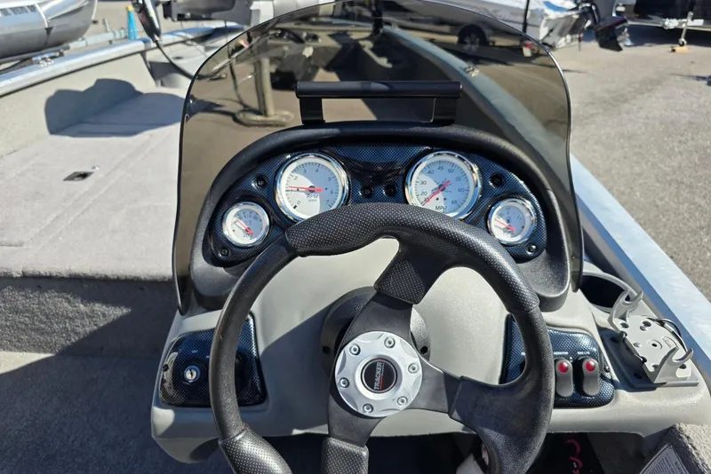 Slide: The Image of Steering console of a 2010 Bass Tracker Pro Crappie 175 boat with gauges and controls. - 13