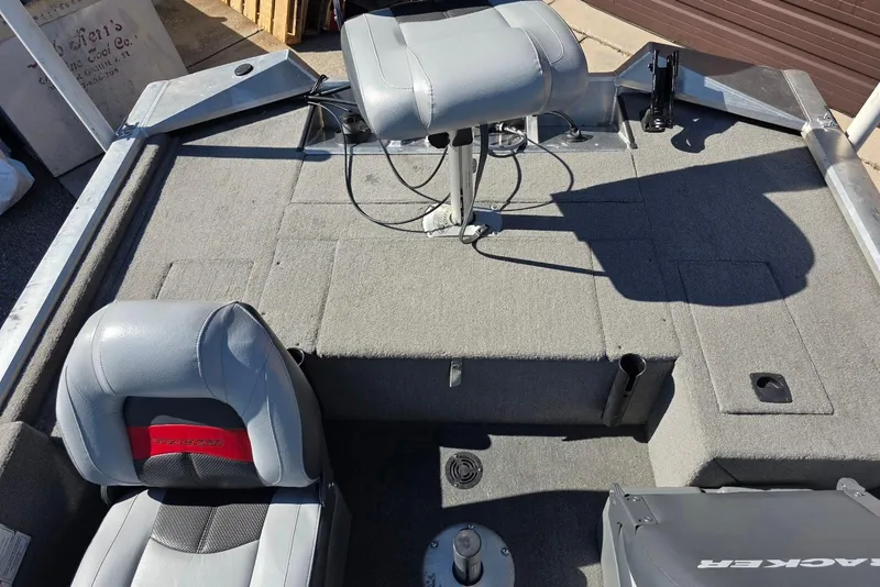 Slide: The Image of 2010 Bass Tracker Pro Crappie 175 boat interior with gray seating and carpeted deck. - 14