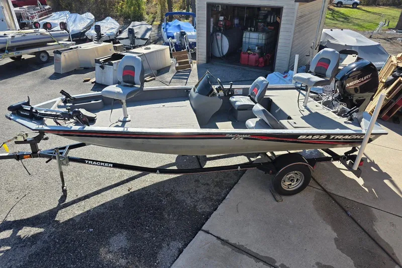Slide: The Image of 2010 Bass Tracker Pro Crappie 175 fishing boat on trailer, parked near a garage. - 19