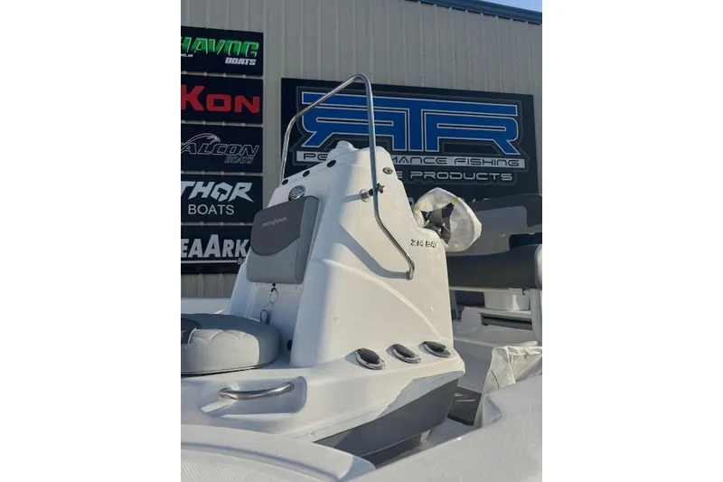 Slide: The Image of 2025 NauticStar 214 Bay boat console with seating, showcased at a marine dealership. - 5