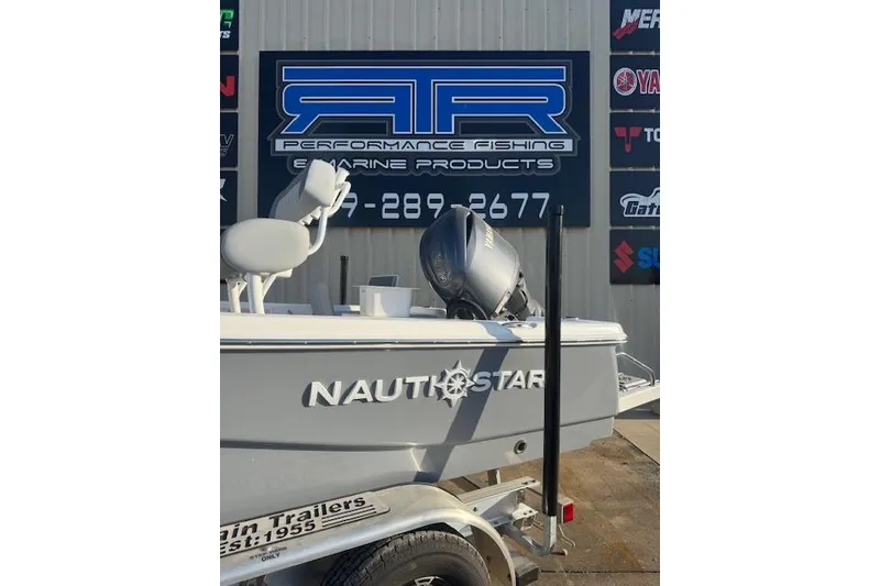Slide: The Image of 2025 NauticStar 214 Bay boat displayed at a marine products store. - 6