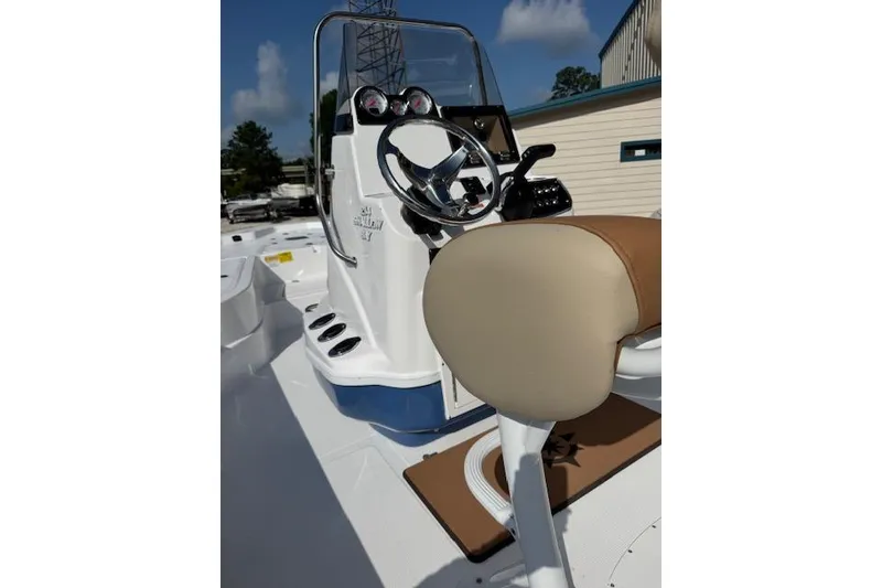 Slide: The Image of 2025 NauticStar 214 Shallow Bay boat interior with steering wheel and seating. - 3