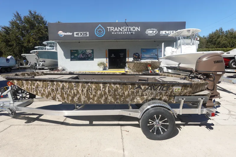 The Image of 2026 Avid 16 Commander boat with camouflage design at Transition Watersports dealership. - 12