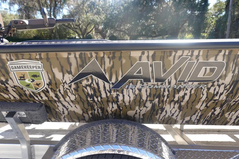 Slide: The Image of 2026 Avid 16 Commander boat with camouflage design and Gamekeeper logo. - 16