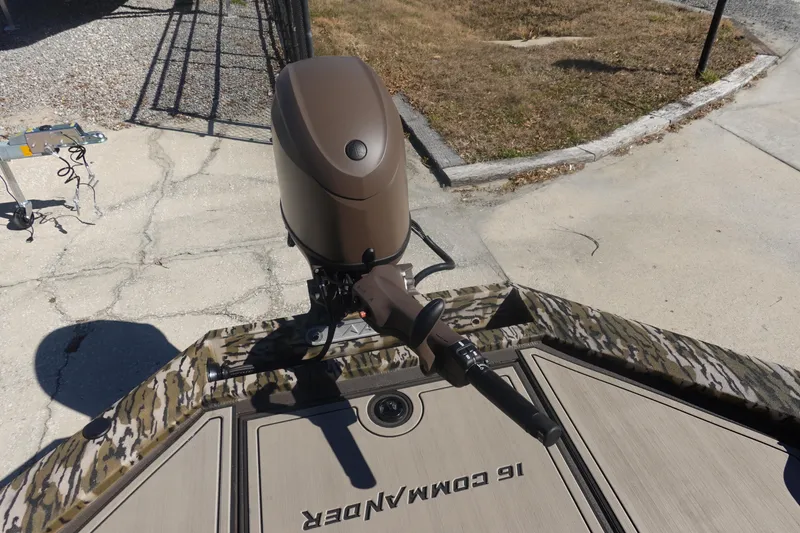 Slide: The Image of 2026 Avid 16 Commander boat with camouflage design and outboard motor. - 20