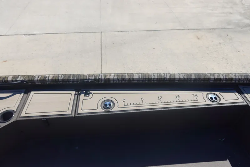 Slide: The Image of Dashboard of 2026 Avid 16 Commander boat with measurement scale and cup holders. - 24