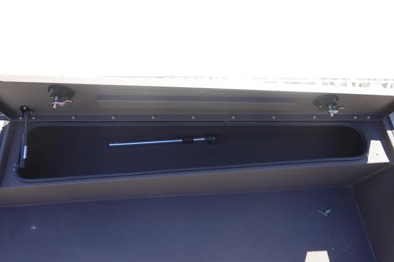 Slide: The Image of Storage compartment of 2026 Avid 16 Commander boat, featuring secure latches and hydraulic support. - 26