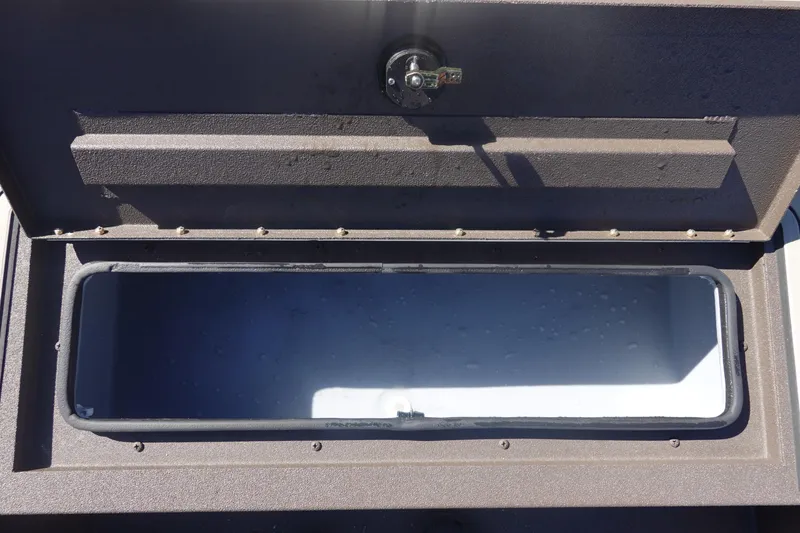 Slide: The Image of Open storage compartment of 2026 Avid 16 Commander boat, showing interior space. - 28