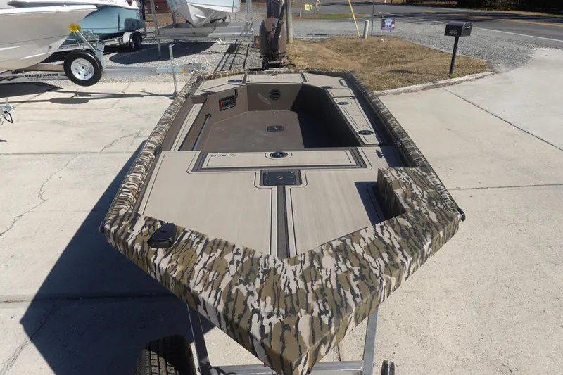 Slide: The Image of 2026 Avid 16 Commander boat with camouflage design on a trailer. - 30