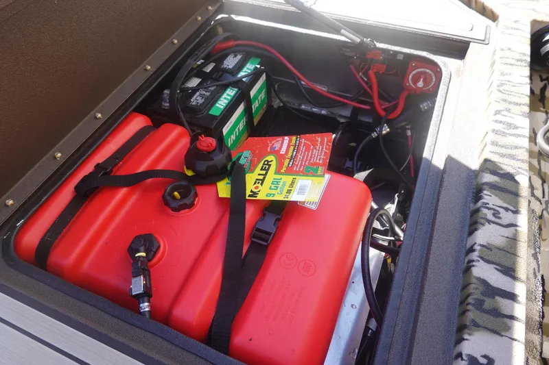 Slide: The Image of Avid 16 Commander 2026 boat battery compartment with red fuel tank and wiring. - 31