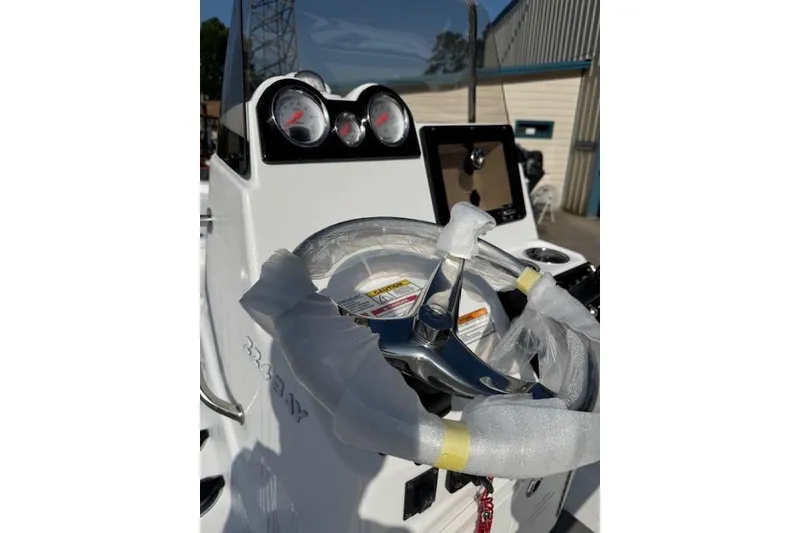 Slide: The Image of 2025 NauticStar 224 Bay boat dashboard with wrapped steering wheel and gauges. - 3