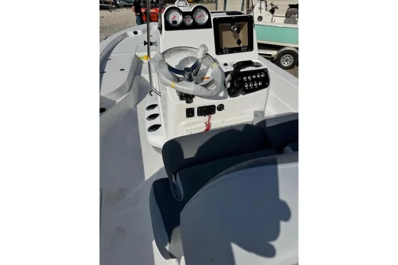 Slide: The Image of 2025 NauticStar 224 Bay boat dashboard with steering wheel and controls. - 4