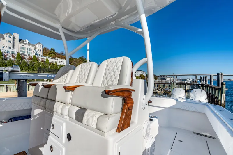 Slide: The Image of Luxurious seating on 2025 Front Runner 43 Catamaran, docked by scenic waterfront. - 12