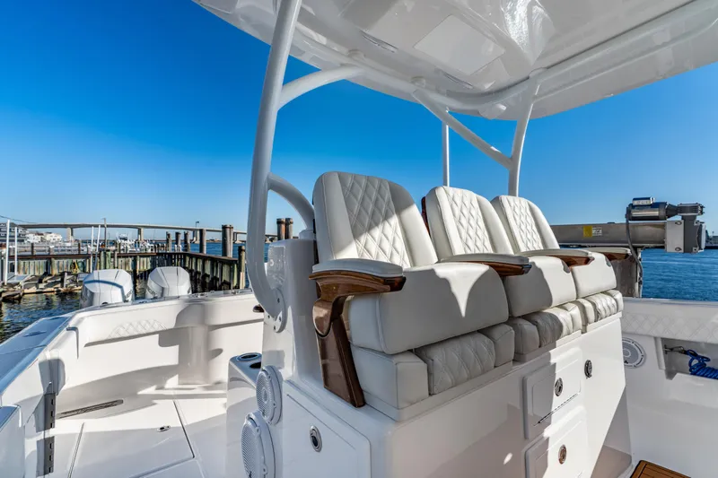Slide: The Image of Luxurious seating on 2025 Front Runner 43 Catamaran, docked with clear blue sky backdrop. - 13