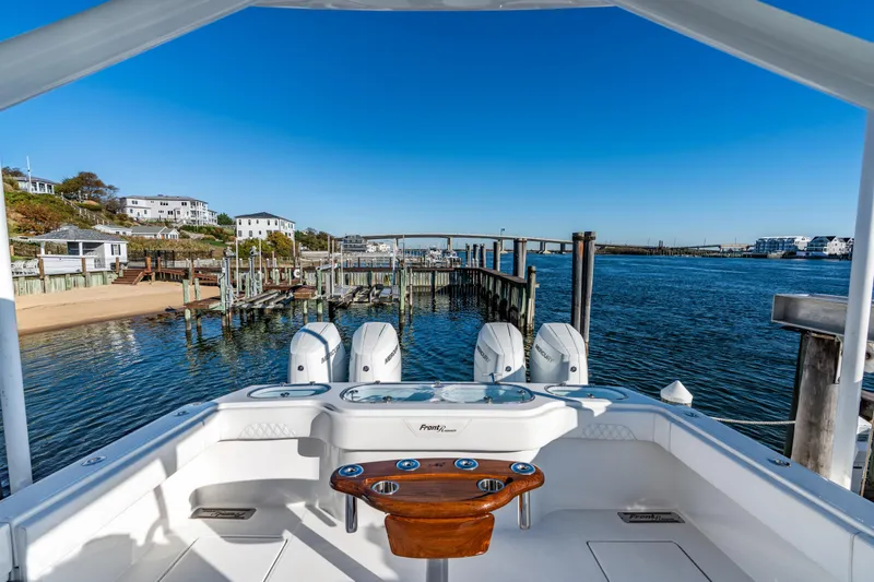 Slide: The Image of 2025 Front Runner 43 Catamaran docked at scenic waterfront with clear blue skies. - 17
