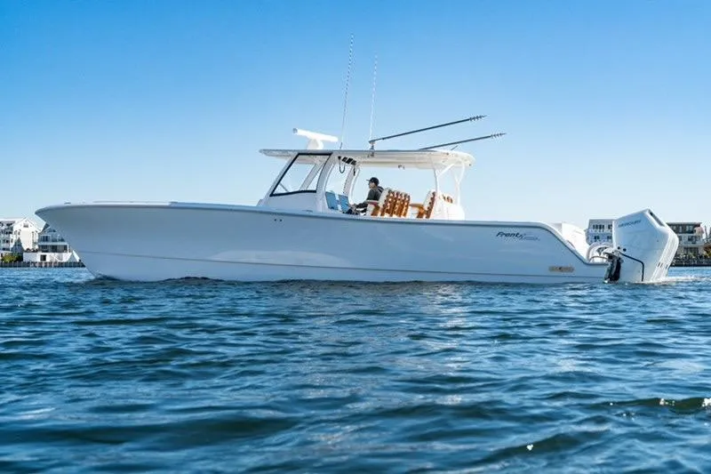 Slide: The Image of 2025 Front Runner 43 Catamaran cruising on calm waters under clear blue sky. - 2