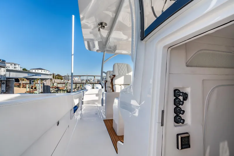 Slide: The Image of 2025 Front Runner 43 Catamaran deck view with modern controls and seating. - 20