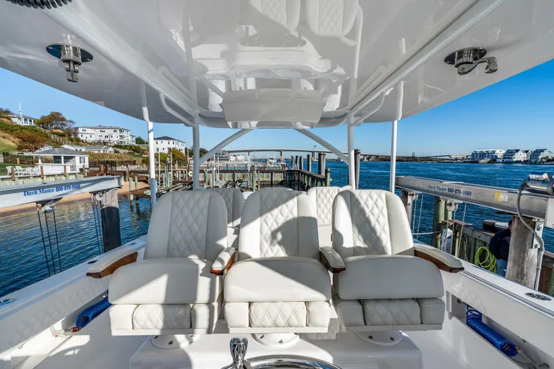 Slide: The Image of Luxurious seating on 2025 Front Runner 43 Catamaran, docked at a scenic marina. - 25