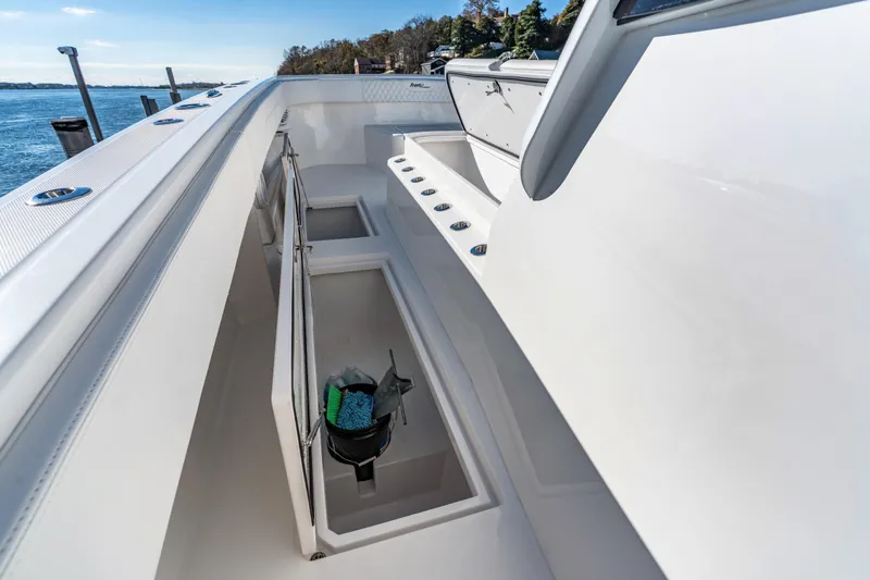 Slide: The Image of 2025 Front Runner 43 Catamaran deck with storage compartments and ocean view. - 31