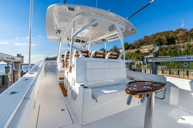 Slide: The Image of Front Runner 43 Catamaran 2025, sleek design, luxurious seating, docked by scenic waterfront. - 4