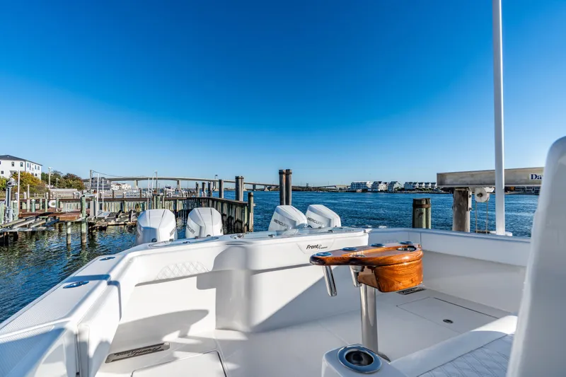 Slide: The Image of 2025 Front Runner 43 Catamaran docked, showcasing sleek design and powerful engines. - 5