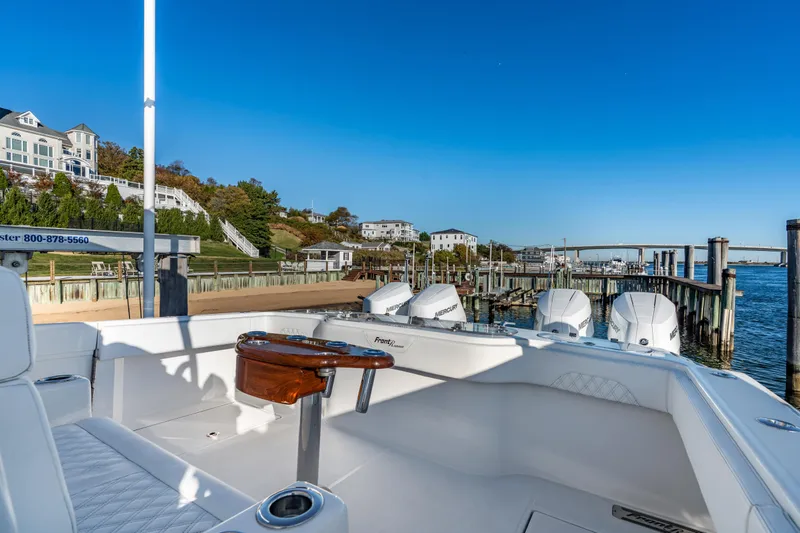 Slide: The Image of 2025 Front Runner 43 Catamaran docked at scenic marina with clear blue sky. - 6