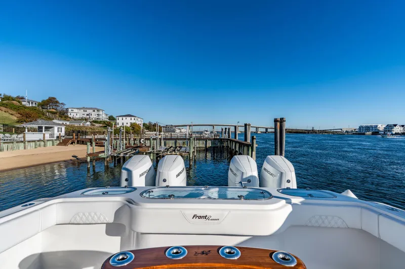 Slide: The Image of 2025 Front Runner 43 Catamaran docked by scenic waterfront homes and clear blue sky. - 7