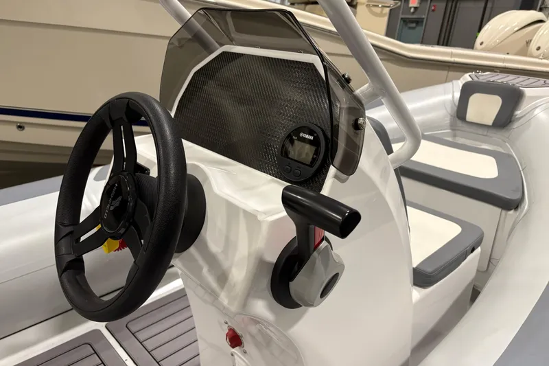 Slide: The Image of 2025 Highfield Classic 400 boat interior with steering wheel and control panel. - 11