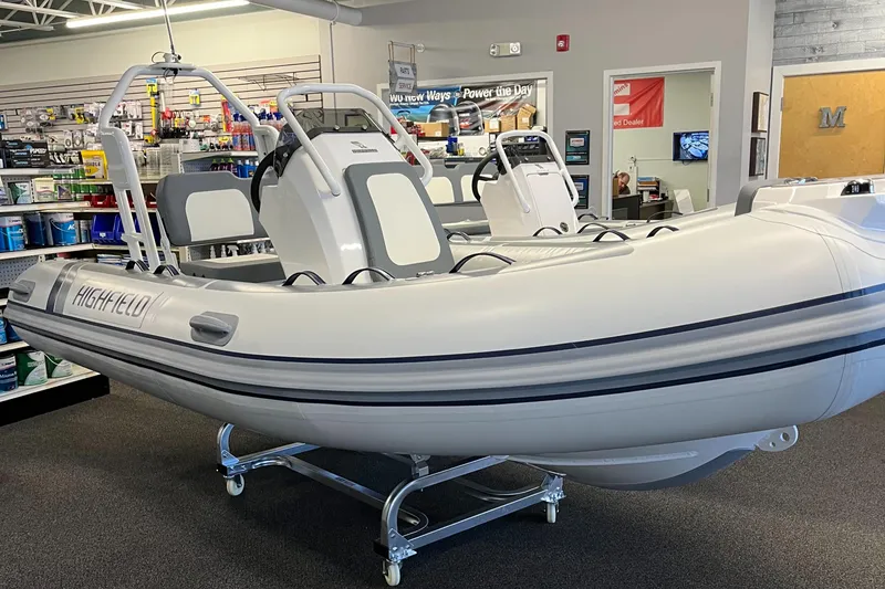 Slide: The Image of 2025 Highfield Classic 400 inflatable boat displayed indoors on a stand. - 12