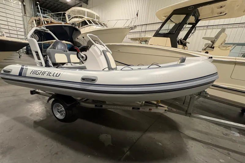 Slide: The Image of 2025 Highfield Classic 400 inflatable boat on trailer in a showroom. - 3