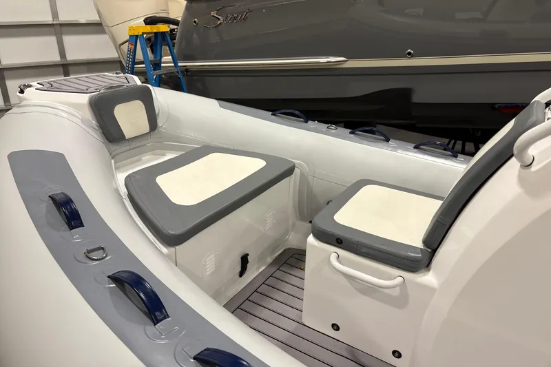 Slide: The Image of 2025 Highfield Classic 400 inflatable boat interior with cushioned seating and storage compartments. - 8