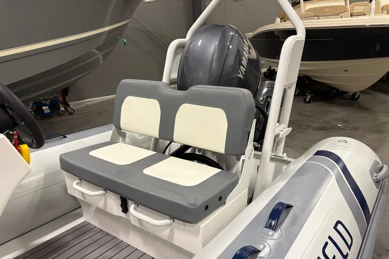 Slide: The Image of 2025 Highfield Classic 400 boat interior with Yamaha engine, featuring dual cushioned seats. - 9