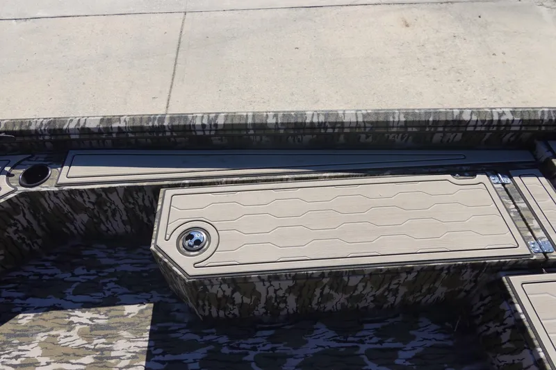 Slide: The Image of 2026 Avid 18 Commander boat interior with camouflage design and storage compartments. - 27